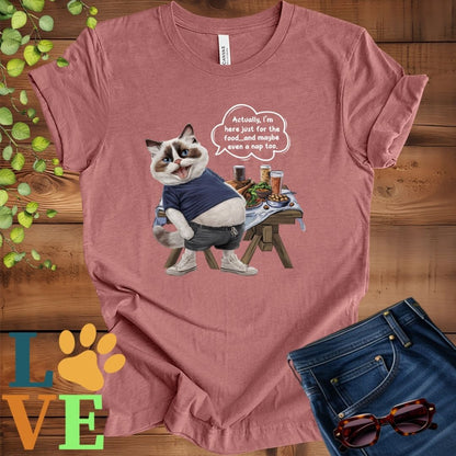 Muted mauve-purple (heather mauve) t-shirt with an anthropomorphic Ragdoll cat, standing in front of a table with food and drinks, showing its pot belly and humorous speech bubble message.
