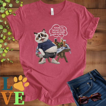 Muted raspberry pink (heather raspberry) t-shirt with an anthropomorphic Ragdoll cat, standing in front of a table with food and drinks, showing its pot belly and humorous speech bubble message.
