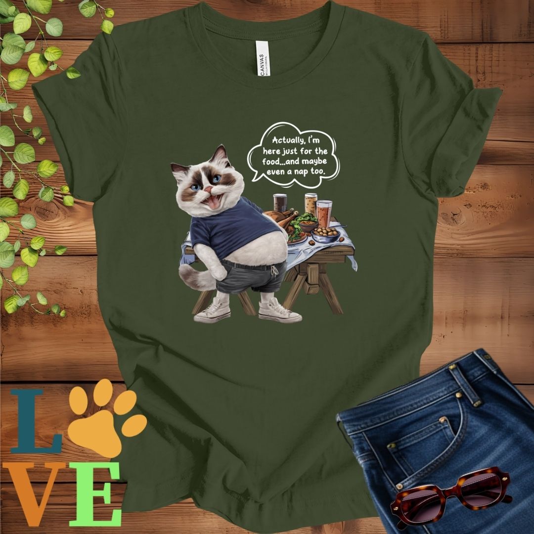 Olive green (military green) t-shirt with an anthropomorphic Ragdoll cat, standing in front of a table with food and drinks, showing its pot belly and humorous speech bubble message.