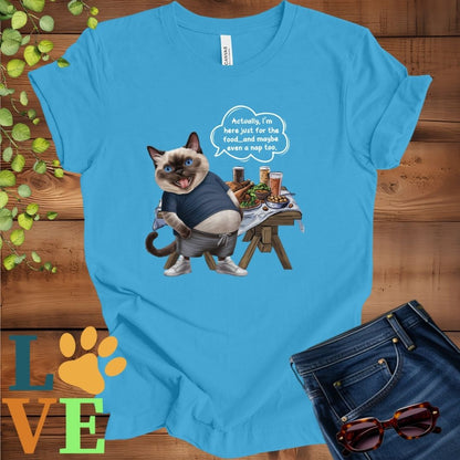 Bright aqua blue t-shirt with an anthropomorphic Siamese cat, standing in front of a table with food and drinks, showing its pot belly and humorous speech bubble message.