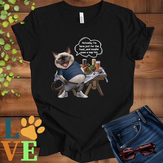 Black t-shirt with an anthropomorphic Siamese cat, standing in front of a table with food and drinks, showing its pot belly and humorous speech bubble message.