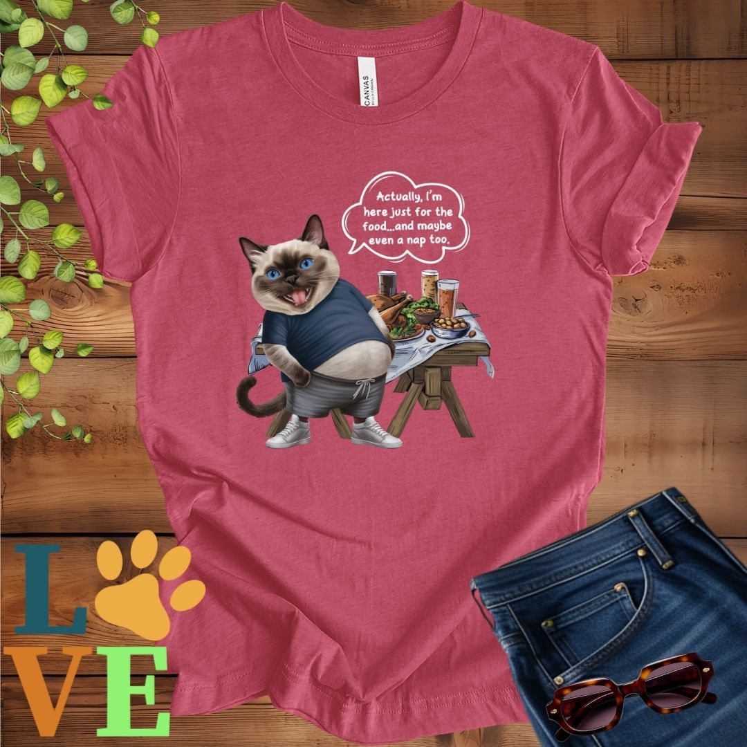 Muted raspberry pink (heather raspberry) t-shirt with an anthropomorphic Siamese cat, standing in front of a table with food and drinks, showing its pot belly and humorous speech bubble message.
