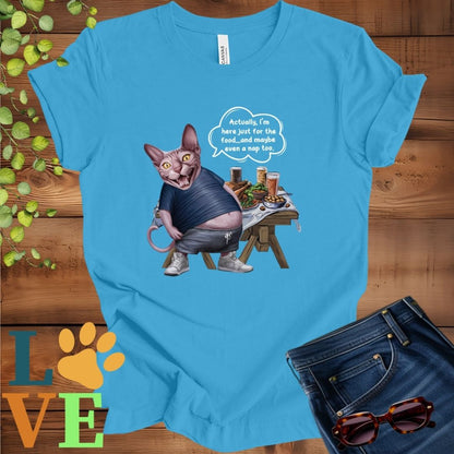 Bright aqua blue t-shirt with an anthropomorphic Sphynx cat, standing in front of a table with food and drinks, showing its pot belly and humorous speech bubble message.