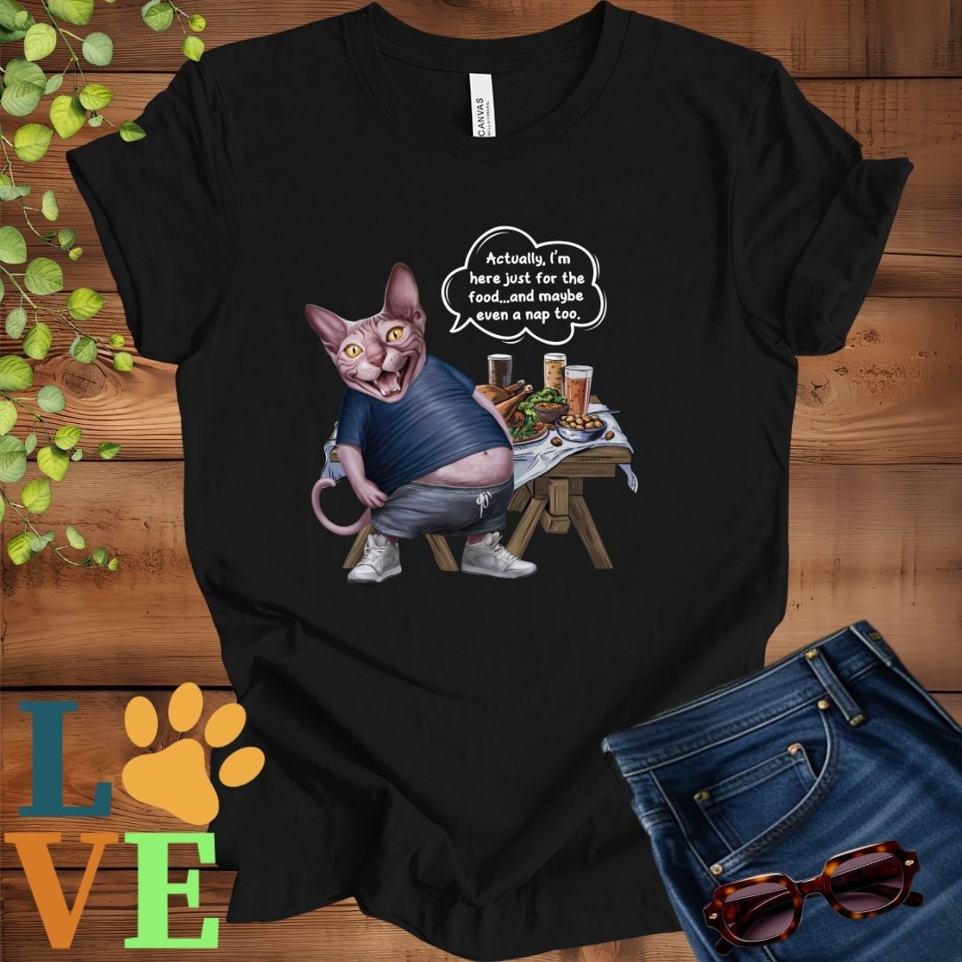 Black t-shirt with an anthropomorphic Sphynx cat, standing in front of a table with food and drinks, showing its pot belly and humorous speech bubble message.