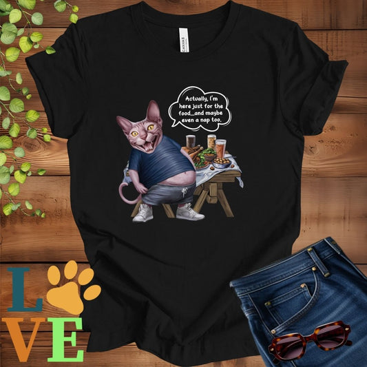Black t-shirt with an anthropomorphic Sphynx cat, standing in front of a table with food and drinks, showing its pot belly and humorous speech bubble message.