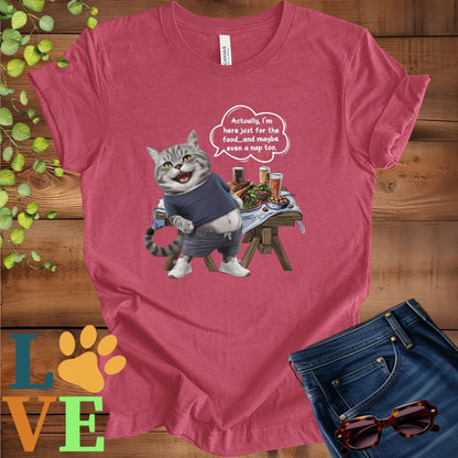 Muted raspberry pink (heather raspberry) t-shirt with an anthropomorphic tabby cat, standing in front of a table with food and drinks, showing its pot belly and humorous speech bubble message.