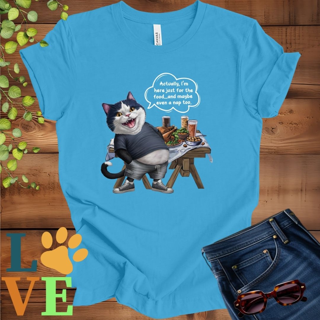 Bright aqua blue t-shirt with an anthropomorphic tuxedo cat, standing in front of a table with food and drinks, showing its pot belly and humorous speech bubble message.