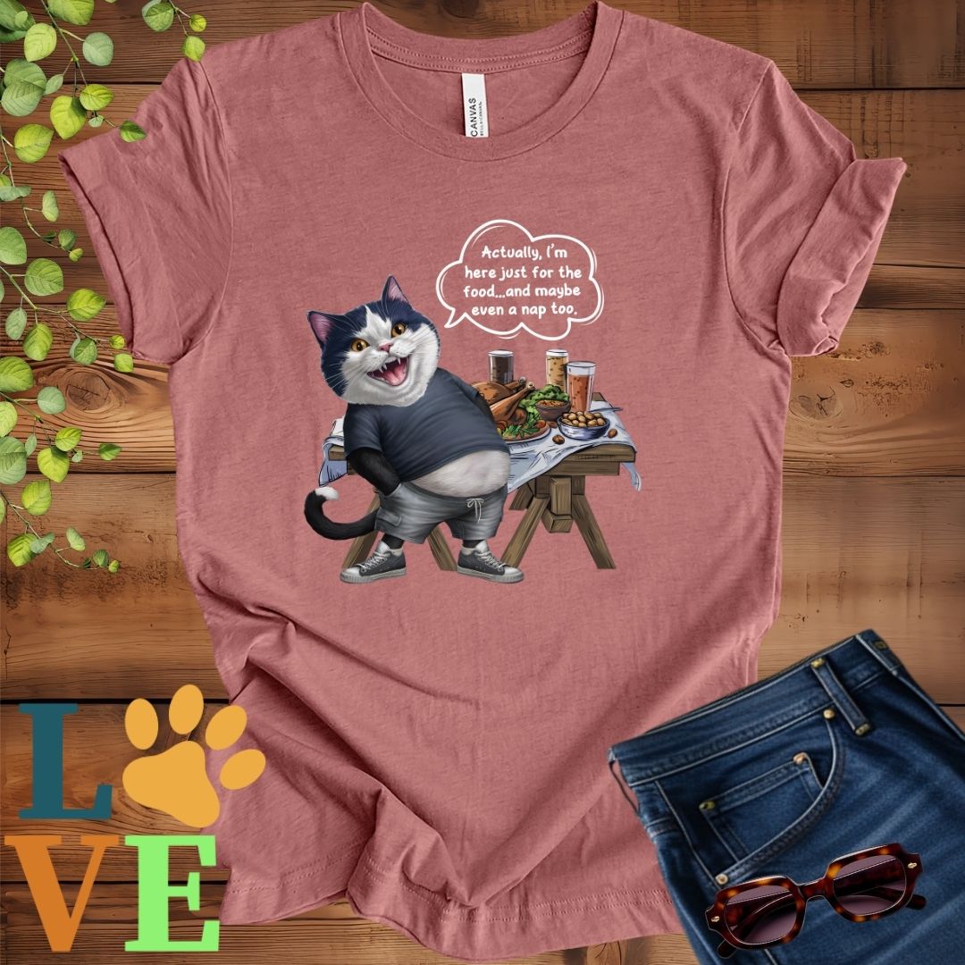 Muted mauve-purple (heather mauve) t-shirt with an anthropomorphic tuxedo cat, standing in front of a table with food and drinks, showing its pot belly and humorous speech bubble message.