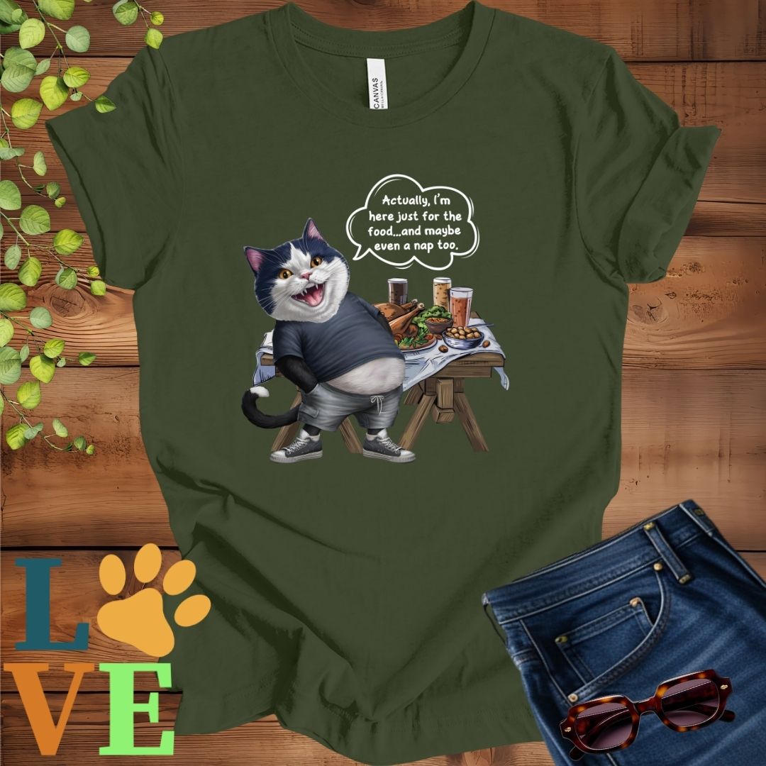 Olive green (military green) t-shirt with an anthropomorphic tuxedo cat, standing in front of a table with food and drinks, showing its pot belly and humorous speech bubble message.