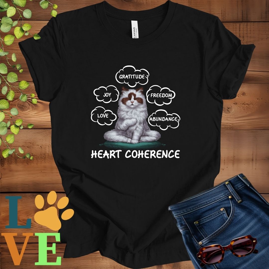 Black t-shirt with a meditating Ragdoll cat, surrounded by floating emotion bubbles labelled love, joy, gratitude, freedom, abundance, and 'Heart Coherence' slogan.
