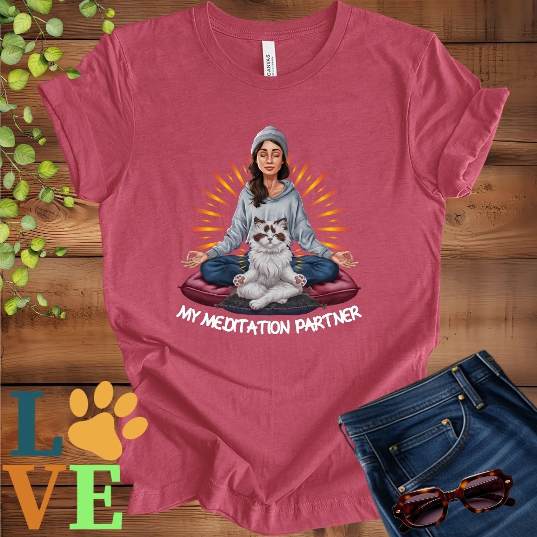 Muted raspberry pink (heather raspberry) t-shirt featuring a woman meditating with her Ragdoll cat and the slogan "My meditation partner".