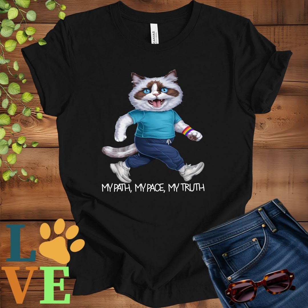Black t-shirt featuring an anthropomorphic Ragdoll cat in exercise wear walking confidently with the slogan, "My path, my pace, my truth."
