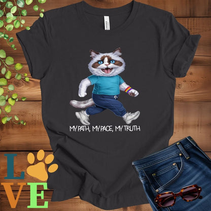 Dark grey heather t-shirt featuring an anthropomorphic Ragdoll cat in exercise wear walking confidently with the slogan, "My path, my pace, my truth."
