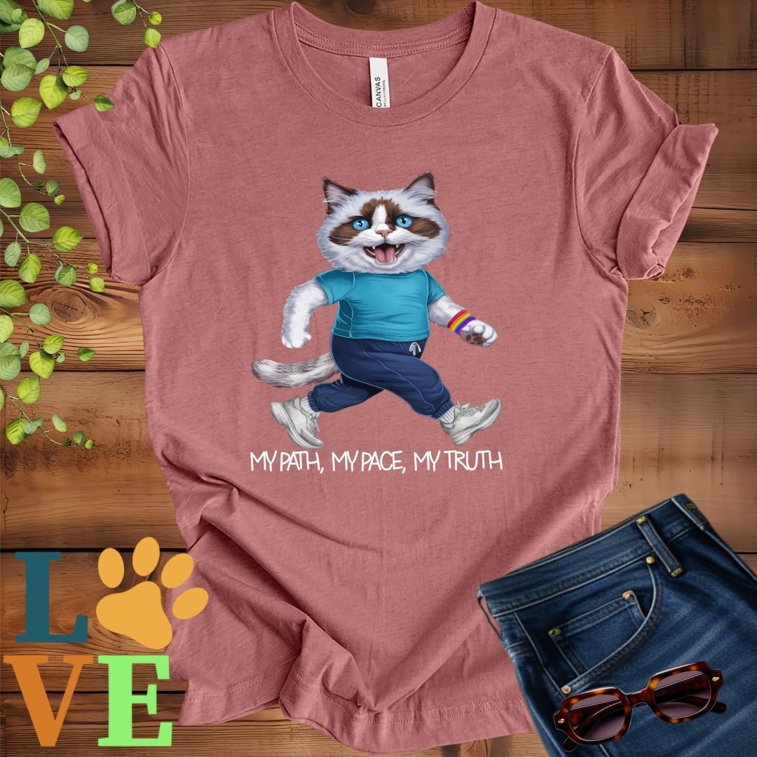 Muted mauve-purple (heather mauve) t-shirt featuring an anthropomorphic Ragdoll cat in exercise wear walking confidently with the slogan, "My path, my pace, my truth."
