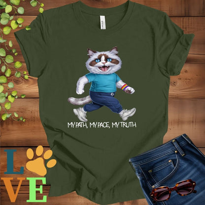 Olive green (military green) t-shirt featuring an anthropomorphic Ragdoll cat in exercise wear walking confidently with the slogan, "My path, my pace, my truth."

