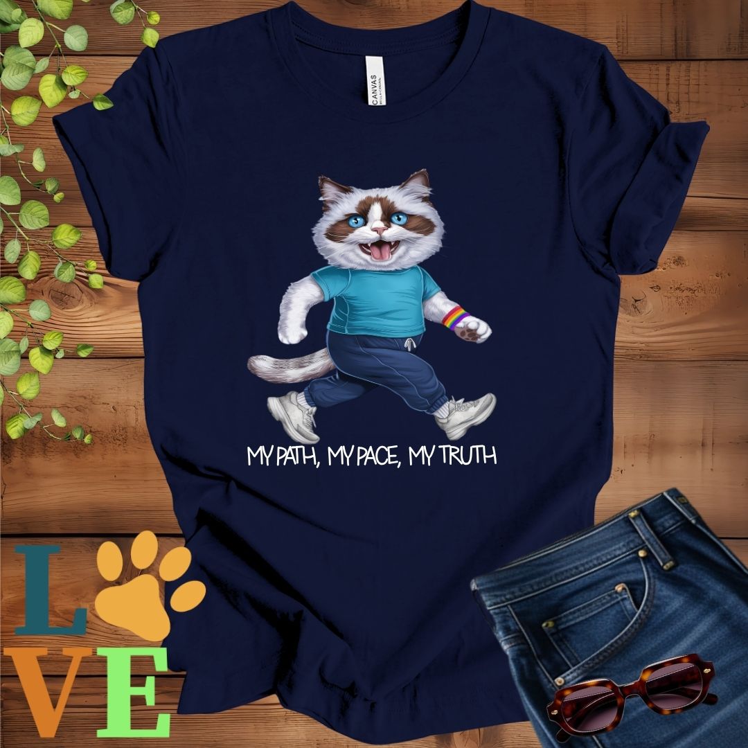 Navy blue t-shirt featuring an anthropomorphic Ragdoll cat in exercise wear walking confidently with the slogan, "My path, my pace, my truth."
