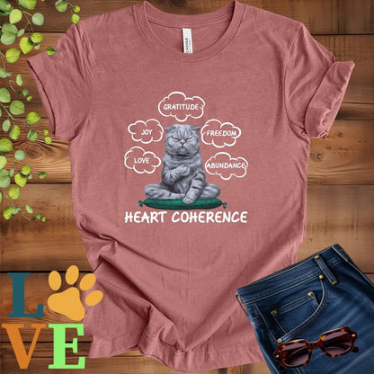 Muted mauve-purple (heather mauve) t-shirt with a meditating Scottish Fold cat, surrounded by floating emotion bubbles labelled love, joy, gratitude, freedom, abundance, and 'Heart Coherence' slogan.