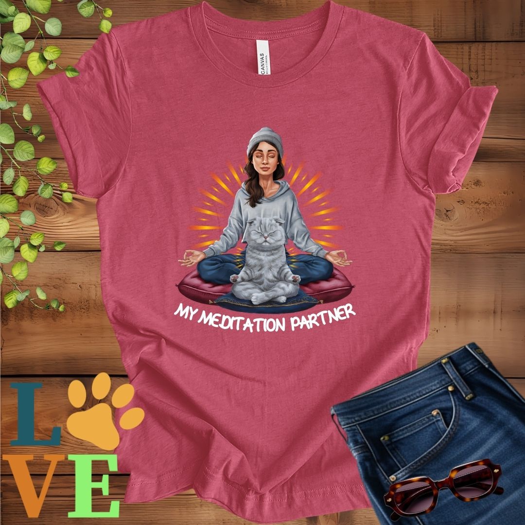 Muted raspberry pink (heather raspberry) t-shirt featuring a woman meditating with her Scottish Fold cat and the slogan "My meditation partner".