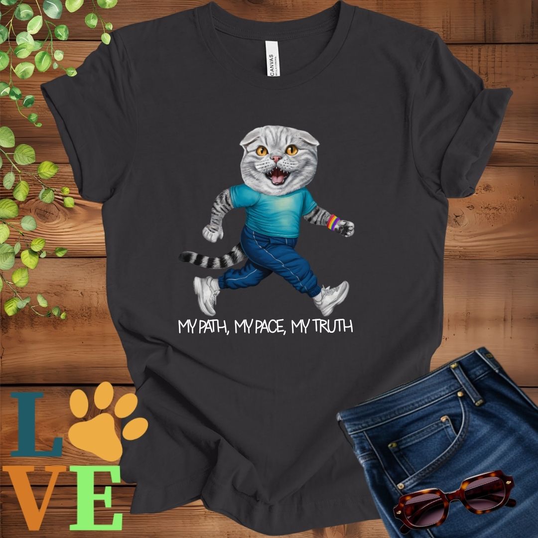 Dark grey heather t-shirt featuring an anthropomorphic Scottish Fold cat in exercise wear walking confidently with the slogan, "My path, my pace, my truth."
