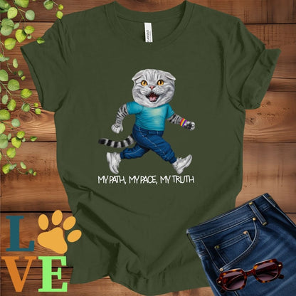 Olive green (military green) t-shirt featuring an anthropomorphic Scottish Fold cat in exercise wear walking confidently with the slogan, "My path, my pace, my truth."