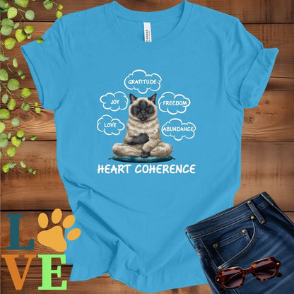 Bright aqua blue t-shirt with a meditating Siamese cat, surrounded by floating emotion bubbles labelled love, joy, gratitude, freedom, abundance, and 'Heart Coherence' slogan.
