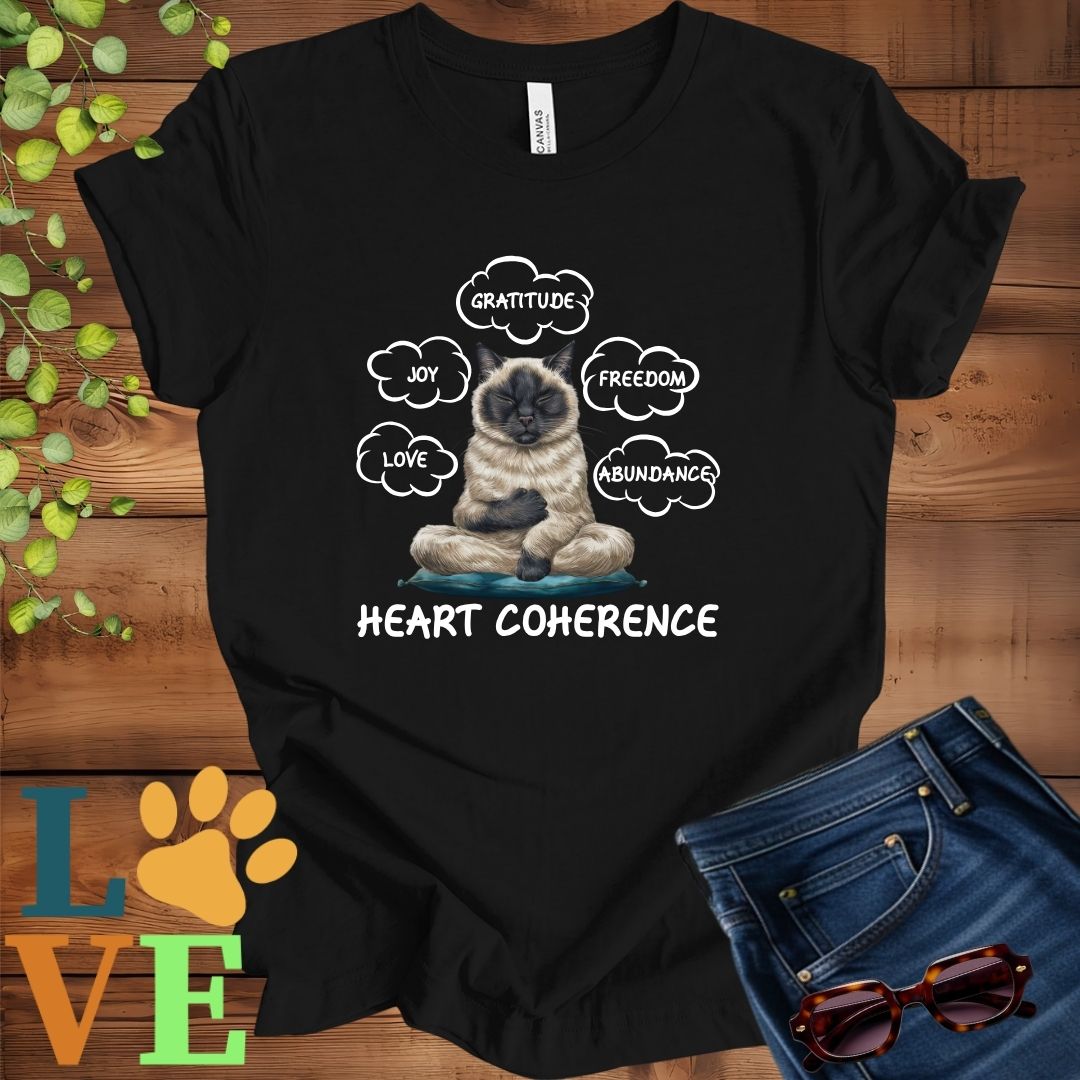 Black t-shirt with a meditating Siamese cat, surrounded by floating emotion bubbles labelled love, joy, gratitude, freedom, abundance, and 'Heart Coherence' slogan.
