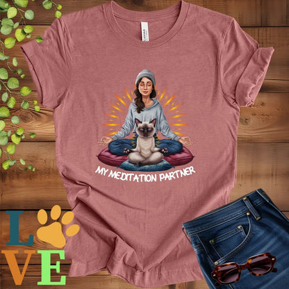 Muted mauve-purple (heather mauve) t-shirt featuring a woman meditating with her Siamese cat and the slogan "My meditation partner".