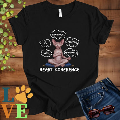 Black t-shirt with a meditating Sphynx cat, surrounded by floating emotion bubbles labelled love, joy, gratitude, freedom, abundance, and 'Heart Coherence' slogan.