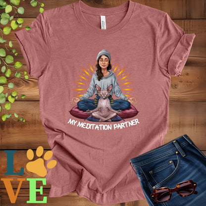 Muted mauve-purple (heather mauve) t-shirt featuring a woman meditating with her Sphynx cat and the slogan "My meditation partner".