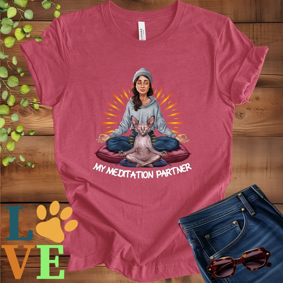 Muted raspberry pink (heather raspberry) t-shirt featuring a woman meditating with her Sphynx cat and the slogan "My meditation partner".