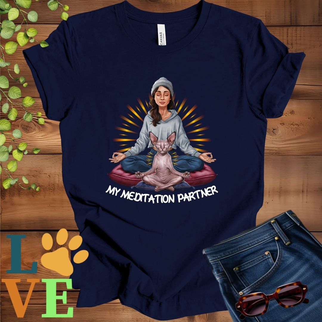Navy blue t-shirt featuring a woman meditating with her Sphynx cat and the slogan "My meditation partner".
