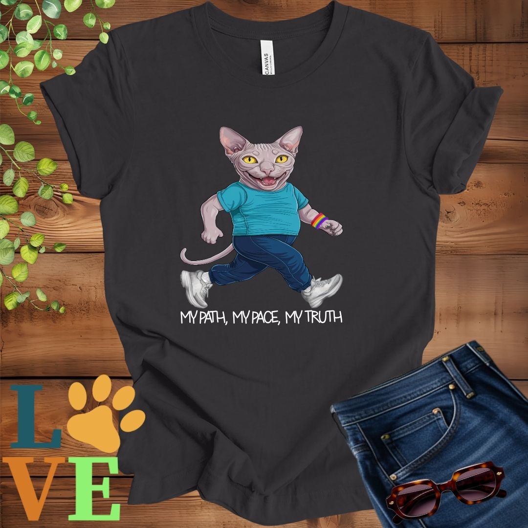 Dark grey heather t-shirt featuring an anthropomorphic Sphynx cat in exercise wear walking confidently with the slogan, "My path, my pace, my truth."


