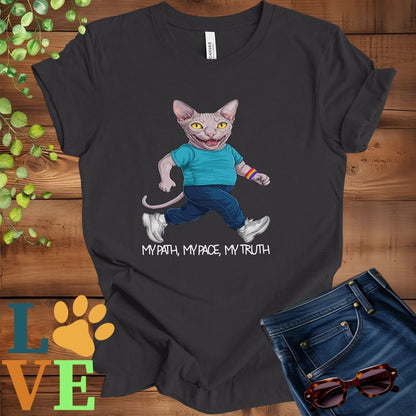 Dark grey heather t-shirt featuring an anthropomorphic Sphynx cat in exercise wear walking confidently with the slogan, "My path, my pace, my truth."


