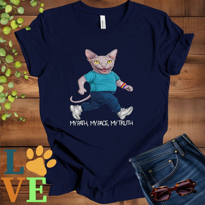 Navy blue t-shirt featuring an anthropomorphic Sphynx cat in exercise wear walking confidently with the slogan, "My path, my pace, my truth."
