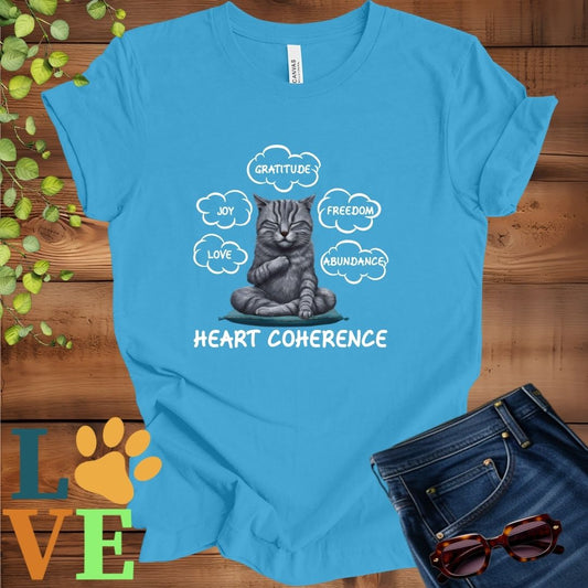 Bright aqua blue t-shirt with a meditating tabby cat, surrounded by floating emotion bubbles labelled love, joy, gratitude, freedom, abundance, and 'Heart Coherence' slogan.
