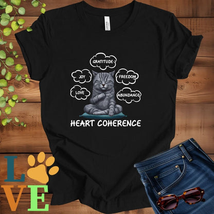 Black t-shirt with a meditating tabby cat, surrounded by floating emotion bubbles labelled love, joy, gratitude, freedom, abundance, and 'Heart Coherence' slogan.