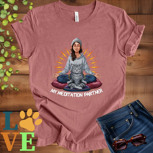 Muted mauve-purple (heather mauve) t-shirt featuring a woman meditating with her tabby cat and the slogan "My meditation partner".