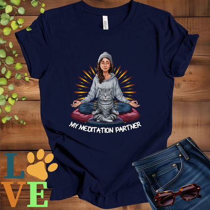 Navy blue t-shirt featuring a woman meditating with her tabby cat and the slogan "My meditation partner".
