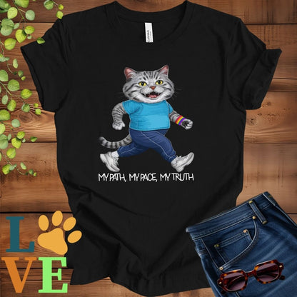Black t-shirt featuring an anthropomorphic tabby cat in exercise wear walking confidently with the slogan, "My path, my pace, my truth."

