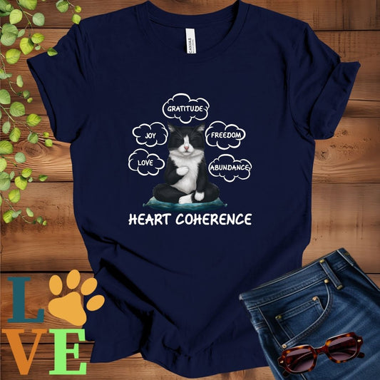 Navy blue t-shirt with a meditating tuxedo cat, surrounded by floating emotion bubbles labelled love, joy, gratitude, freedom, abundance, and 'Heart Coherence' slogan.
